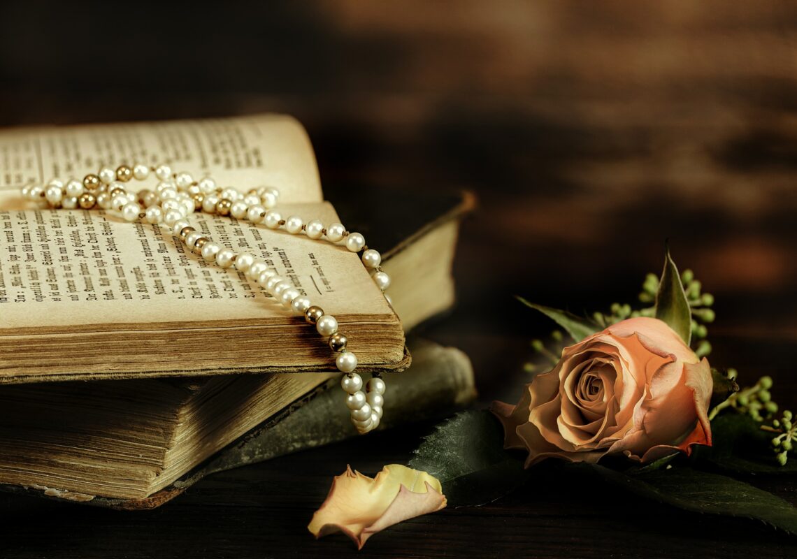 Book with pearls and rose. Dressing Beautifully every day for well-being