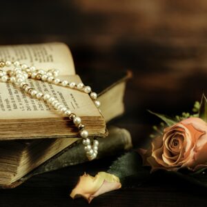 Book with pearls and rose. Dressing Beautifully every day for well-being
