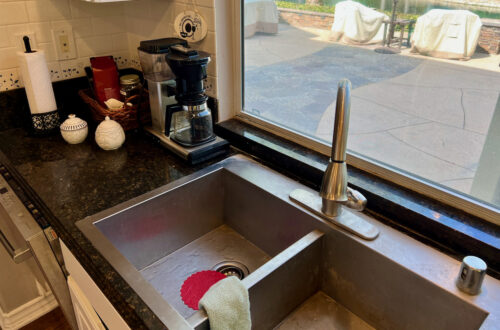 Photo of kitchen sink and red thing.