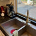Photo of kitchen sink and red thing.