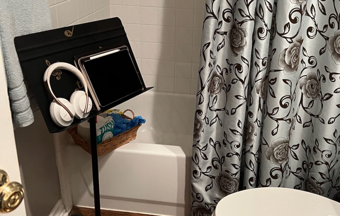 Photo of iPad and headphones on a music stand in a bathroom. How to prepare for a colonoscopy
