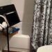 Photo of iPad and headphones on a music stand in a bathroom. How to prepare for a colonoscopy