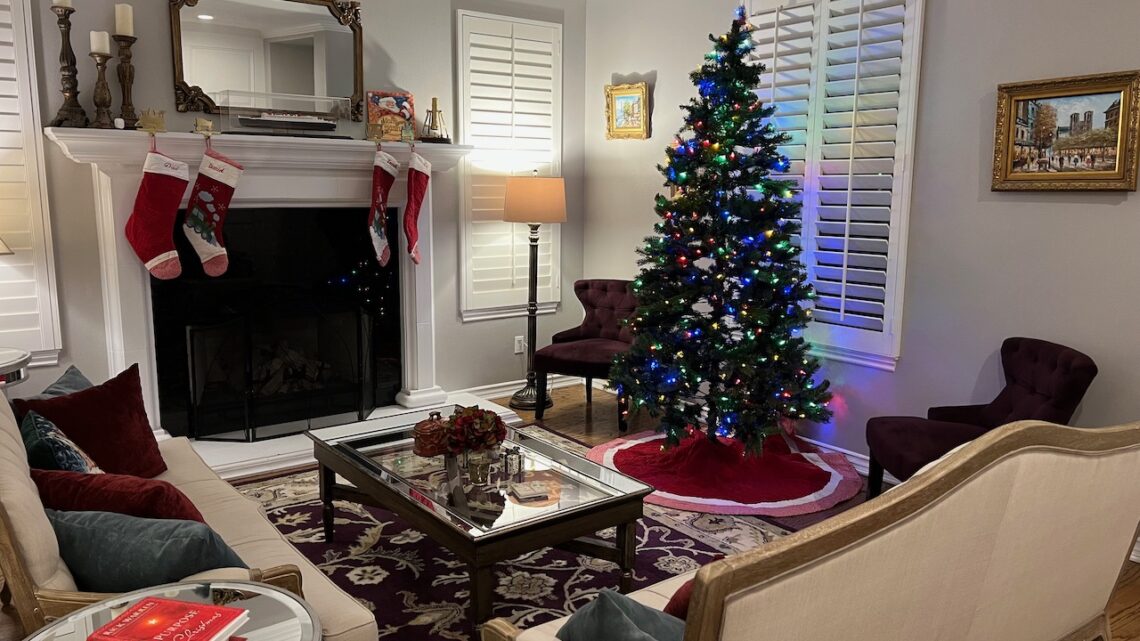 Photo of Author's living room with fireplace, Christmas tree and two couches. Progressive Christmas Decorating