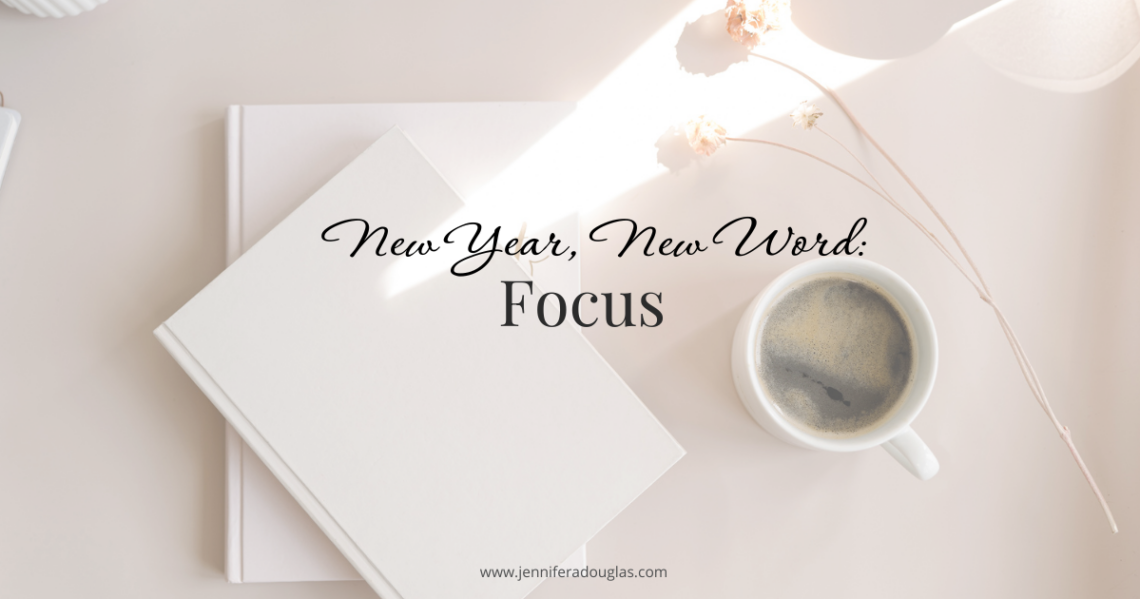 Notebook and coffee on desk. Text says New Year New Word: Focus