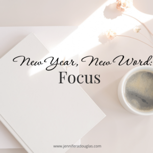 Notebook and coffee on desk. Text says New Year New Word: Focus