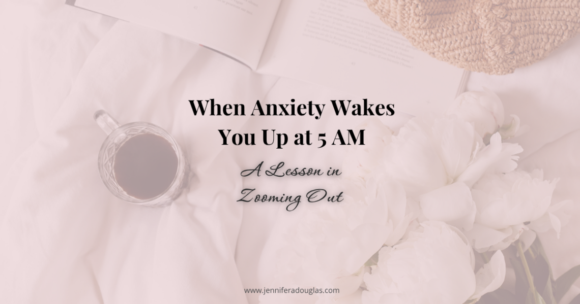 Background image of a bed with a cup of coffee, journal and flowers. Text reads When Anxiety Wakes you up at 5AM: A Lesson in Zooming out
