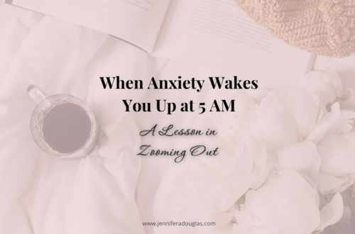 Background image of a bed with a cup of coffee, journal and flowers. Text reads When Anxiety Wakes you up at 5AM: A Lesson in Zooming out