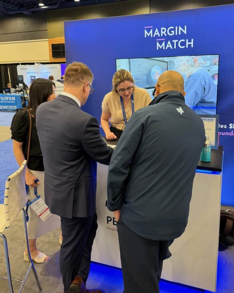 People standing at a booth playing the margin match game
